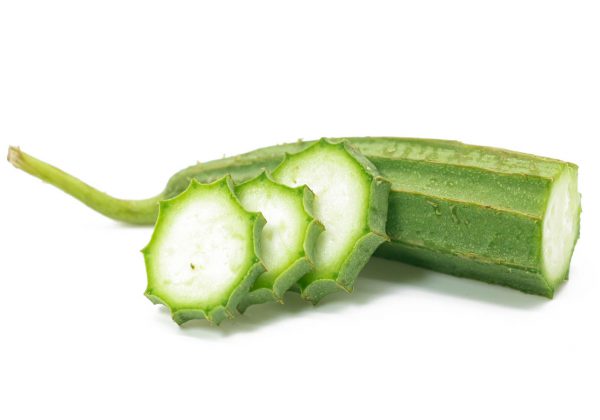 Fresh Angled luffa (Ribbed Gourd) vegetable with slices isolated on white background.
